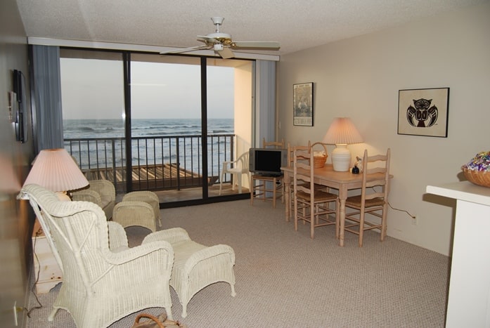 Photo of living room with view of Gulf through windows at West Beach Grand Condominiums