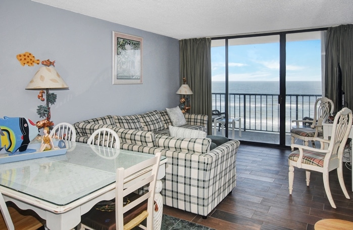 Photo of living/dining room with window and view of Gulf from Riviera I Condominiums