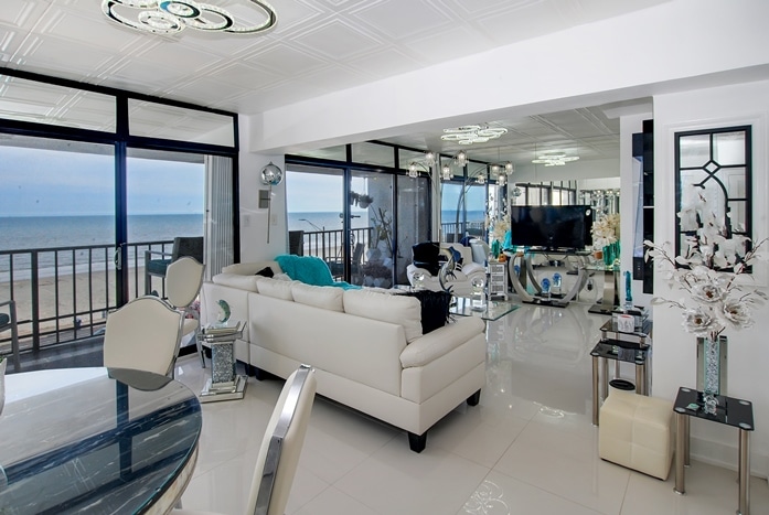 Living and dining room with views at By The Sea Condominiums