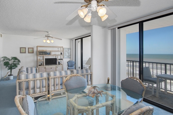 Living and dining room with view of Gulf of Mexico at West Beach Grand Condominiums