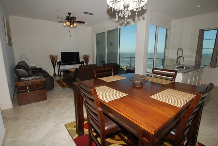 Photo of dining and living room with windows looking at Gulf