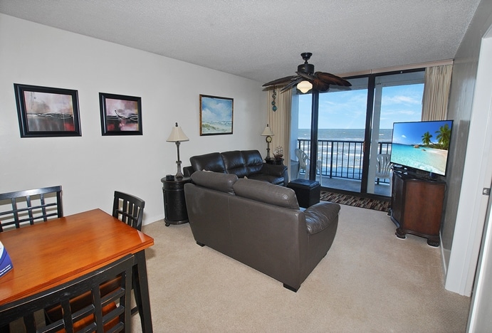 Photo of living room with view of balcony and Gulf of Mexico from West Beach Grand Condominiums