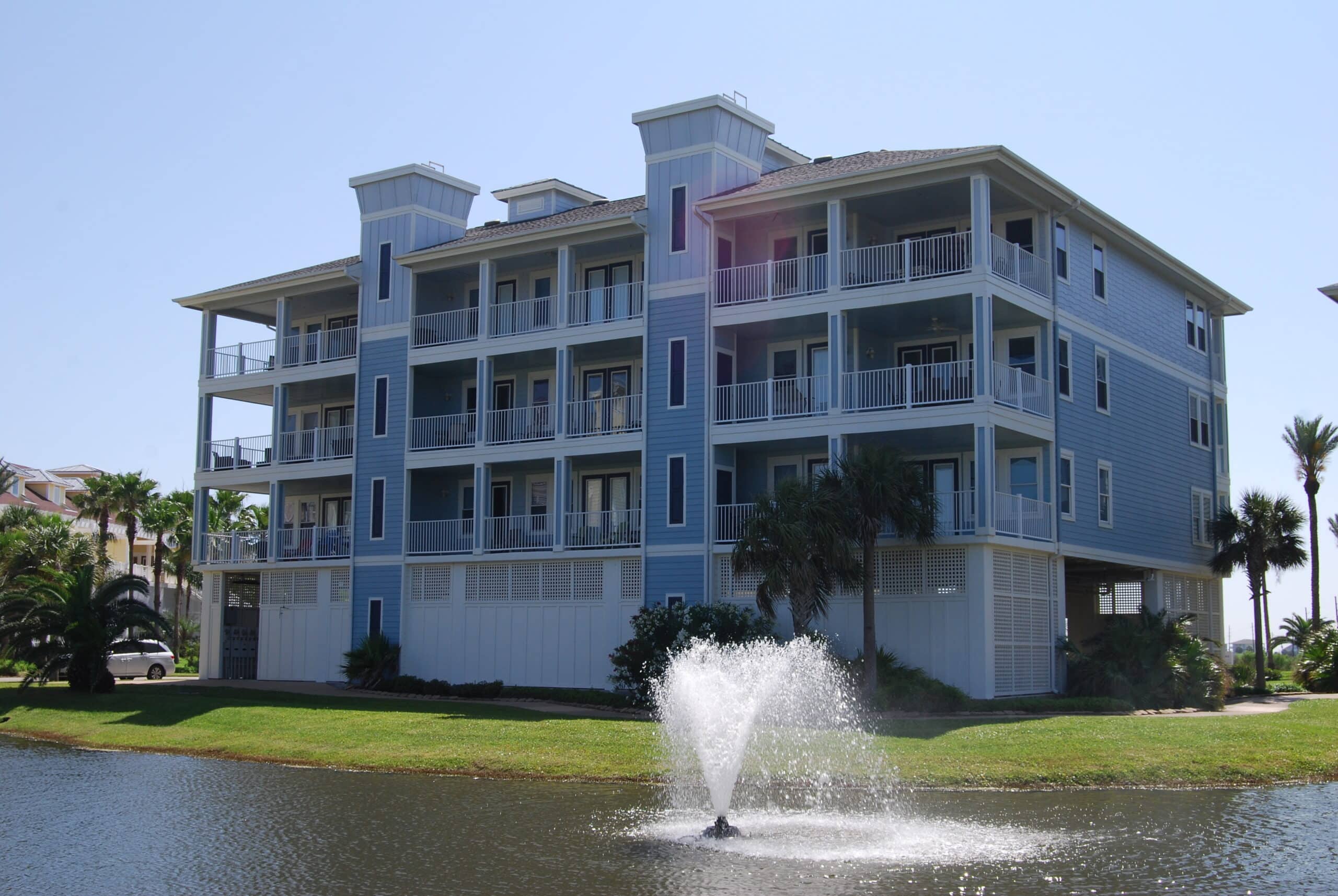 Photo of building at Pointe West Condominiums with fountain