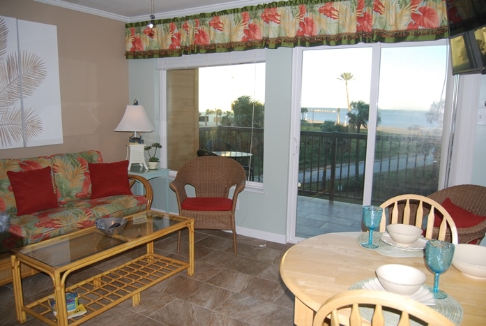 Photo of living room with windows overlooking balcony and Gulf views at Maravilla Condominiums