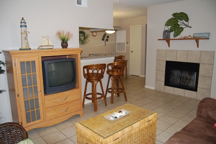 Photo of living room with fireplace at Palms At Cove View Condominiums