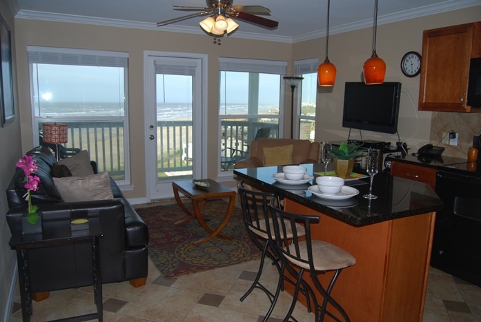 Photo of kitchen and living room with view of Gulf through windows at Seascape Condominiums