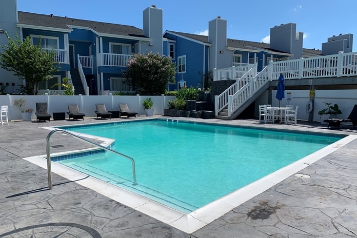 Photo of swimming pool with building at Palms At Cove View Condominiums