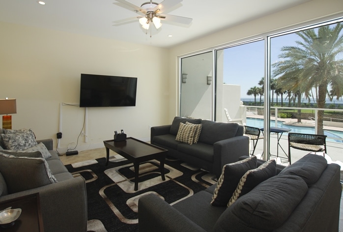 Photo of living room with view of pool from Diamond Beach Condominiums in Galveston