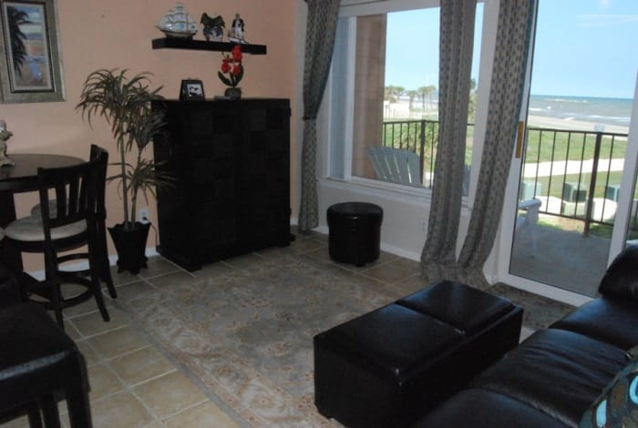 Photo of living room with view of Gulf through windows at Maravilla Condominiums