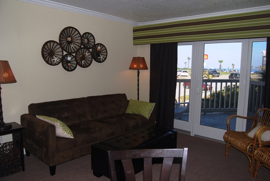 Photo of living room with view of balcony through windows at Victorian Condominiums