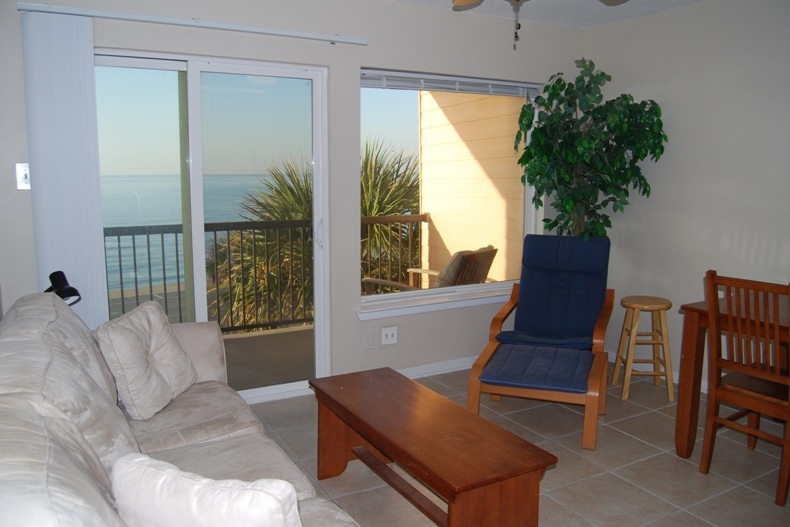 Photo of living room with view of Gulf through windows at Maravilla Condominiums