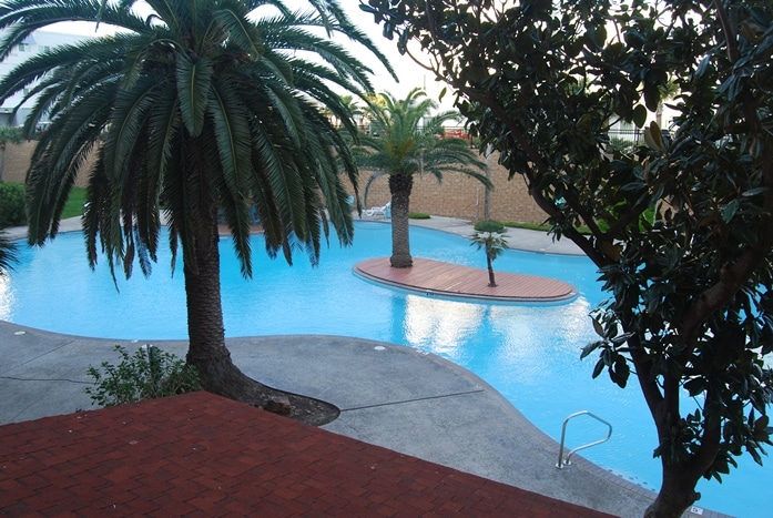 Photo of resort pool from condo balcony at Maravilla Condominiums