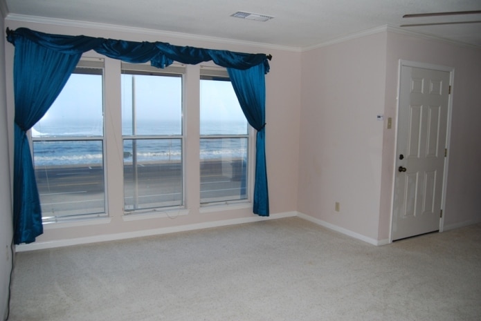 Photo of room with view of Gulf through windows at Sand Castle Condominiums