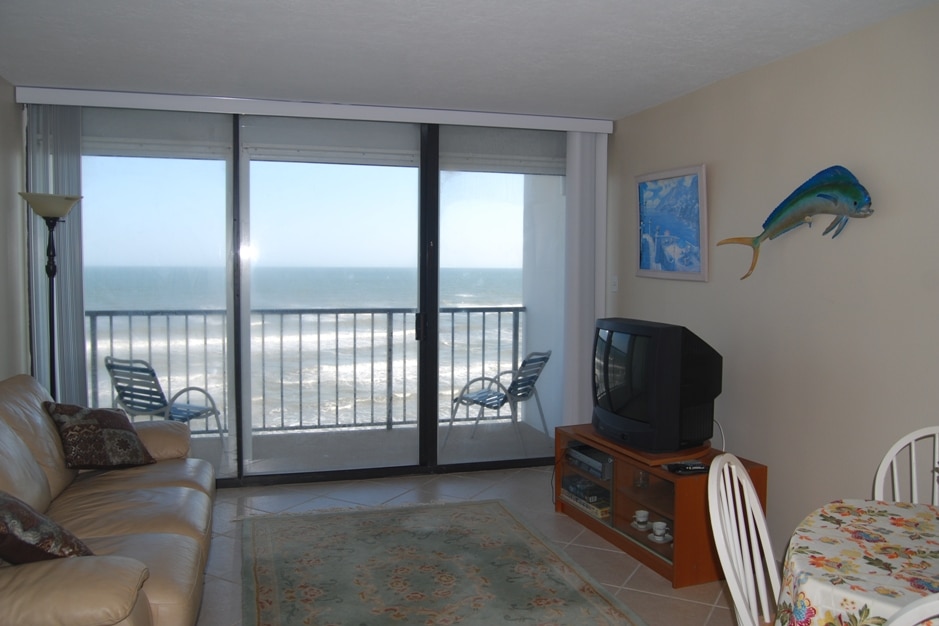 Photo of living room with views of Gulf through patio doors at Riviera II Condominiums