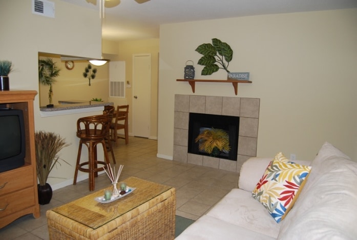 Photo of living room with fireplace at Palms At Cove View Condominiums