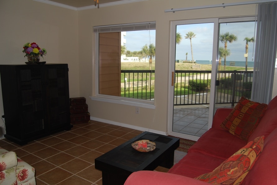 Photo of living room with view of balcony and Gulf at Maravilla Condominiums